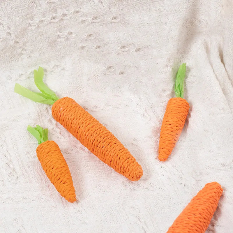 Set of interactive cat toys including paper carrot bites, sticks, and toys with ringing stones.