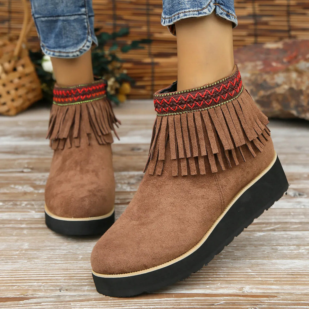 Women's black suede wedge ankle boots with side zipper and decorative tassel on a thick rubber sole.