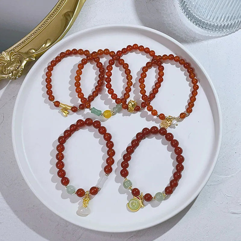 Handcrafted red agate bracelet with Chinese Dragon and Lucky Bag festival motifs