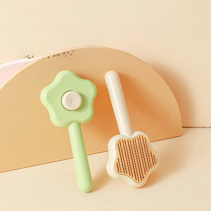 Green self-cleaning cat comb with stainless steel needles measuring 20 cm long