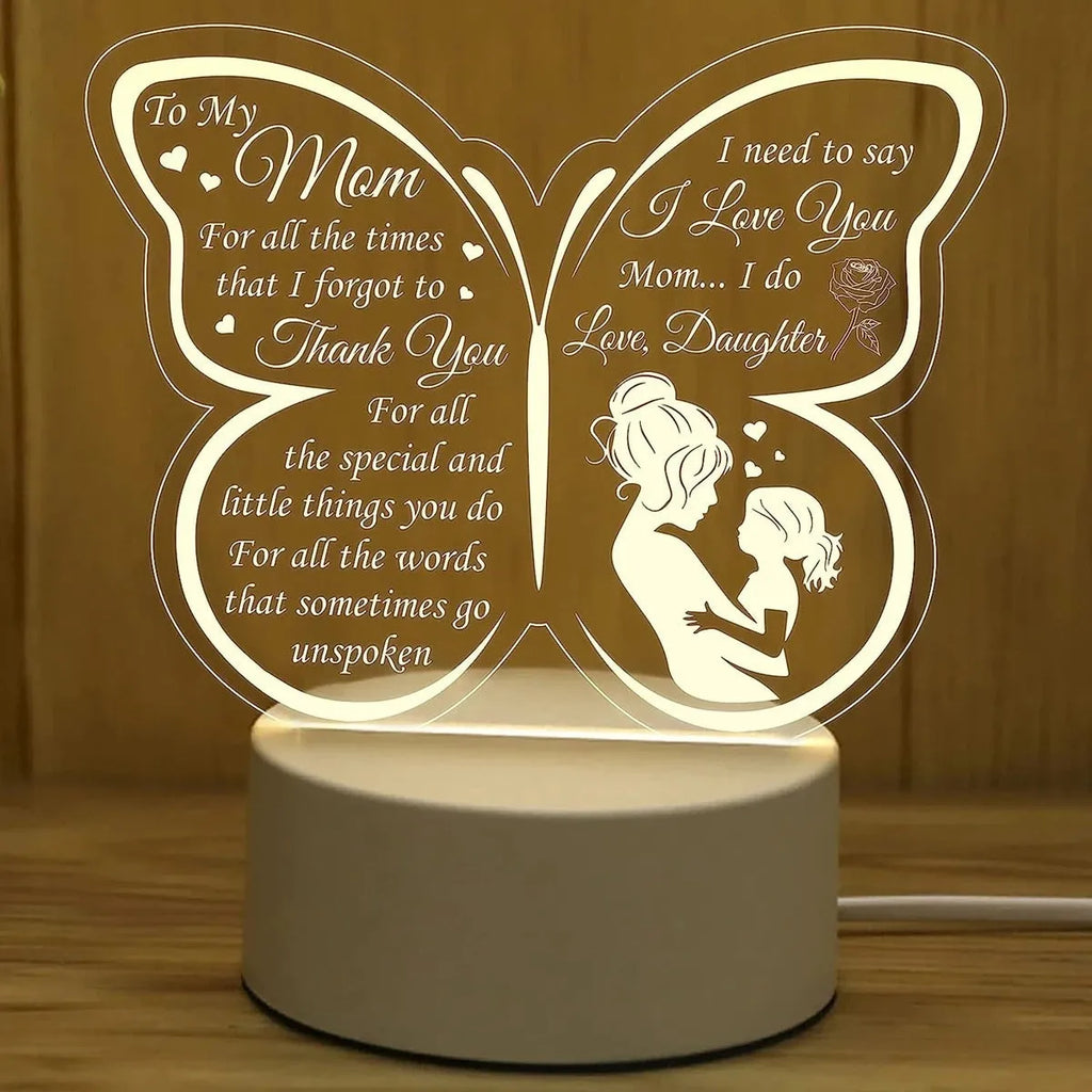 Modern white heart-shaped table lamp with acrylic shade on a wooden surface.