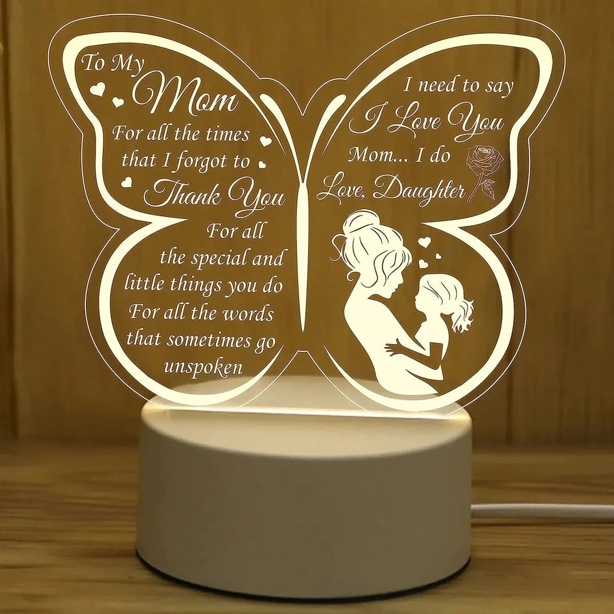 Modern white heart-shaped table lamp with acrylic shade on a wooden surface.