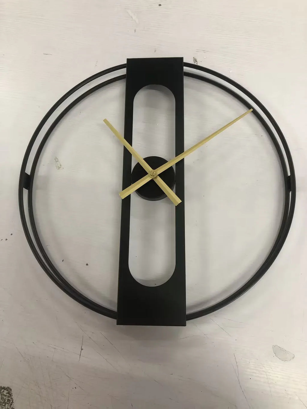 Round metal wall clock measuring 50cm in diameter, available in black and gold colour options