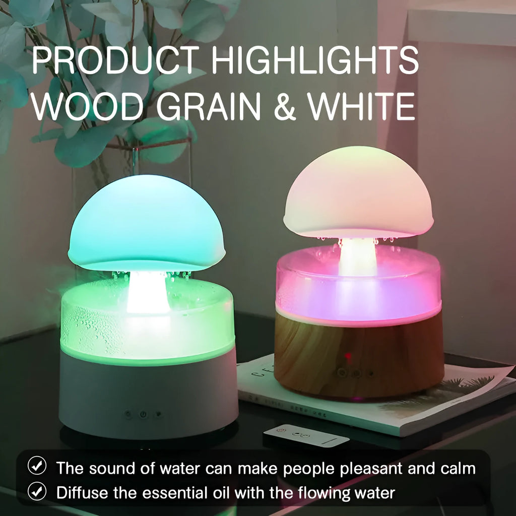 White cloud-shaped humidifier on a table emitting mist and showing coloured LED lights inside, with a remote control beside it.