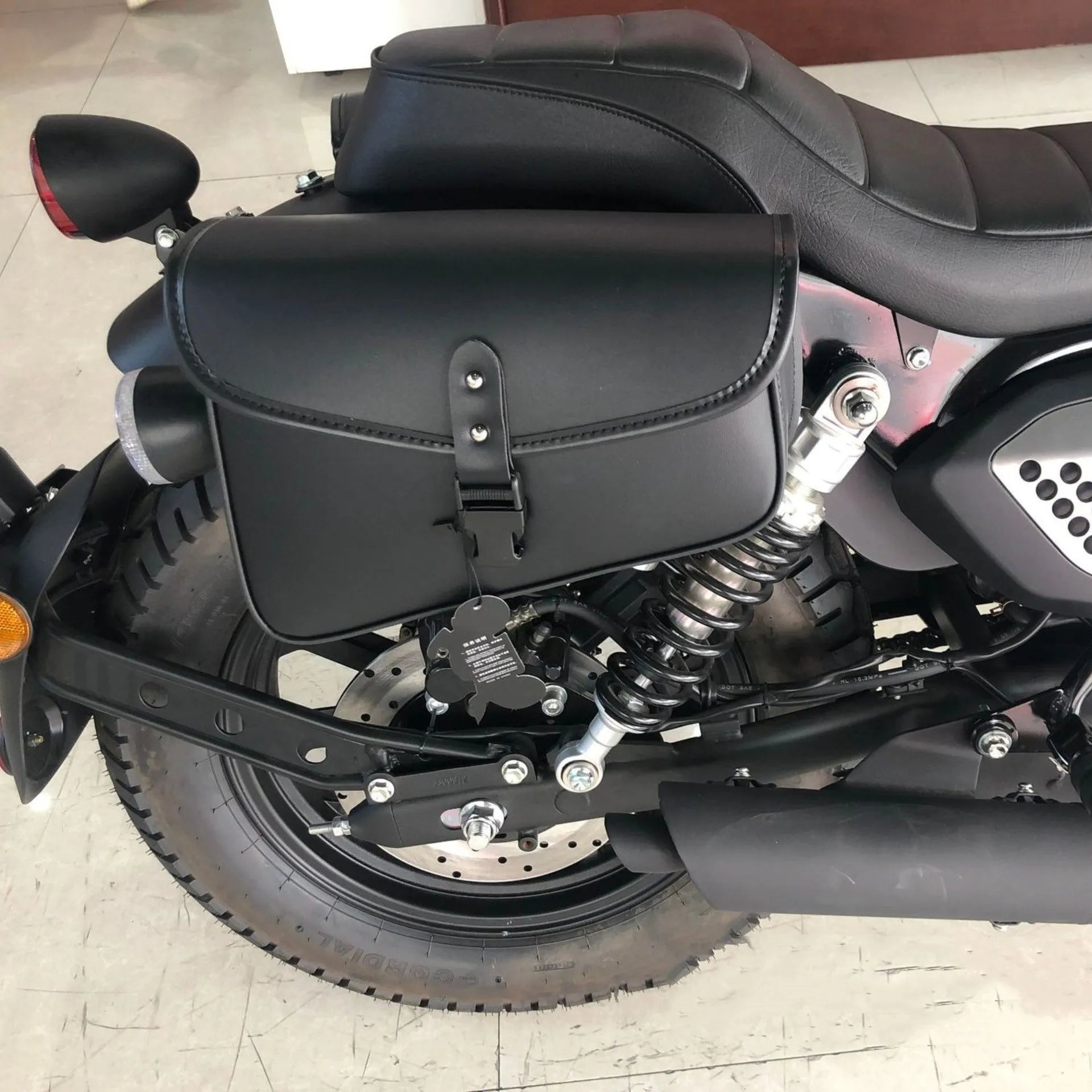 Black PU leather motorcycle swingarm bag mounted on Harley Sportster side storage