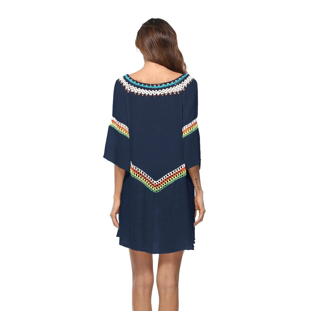 Crocheted white ethnic-style beach cover-up for women, shown as sun protection clothing.