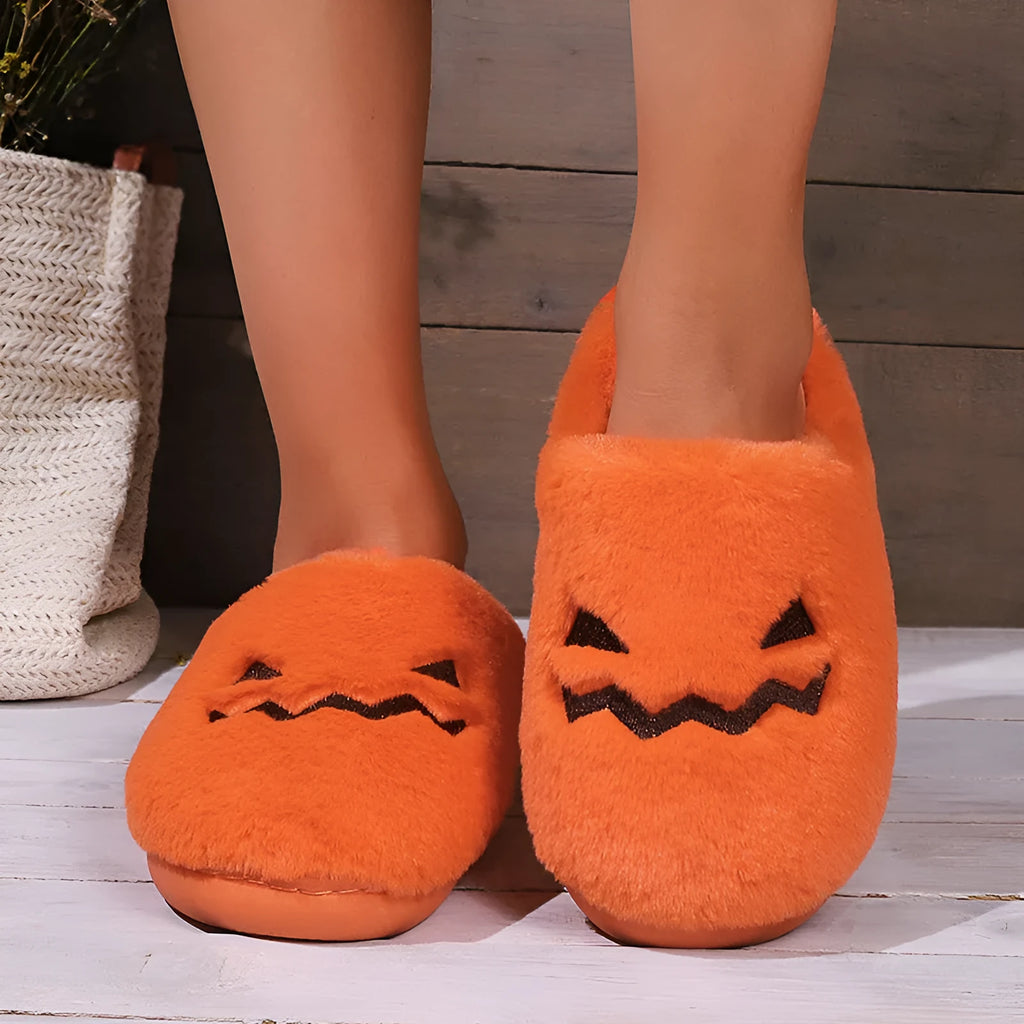 Orange Halloween pumpkin slippers with coral velvet upper and plush lining.