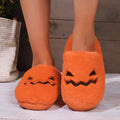 Orange Halloween pumpkin slippers with coral velvet upper and plush lining.