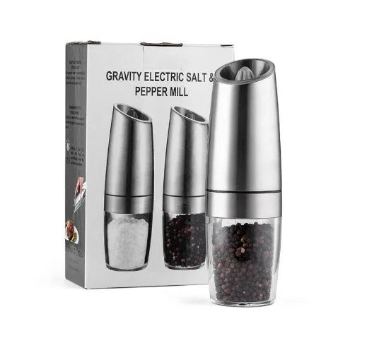 Electric gravity pepper grinder with clear acrylic body and blue LED light on a kitchen countertop