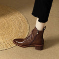 Women's black pointed-toe short tube boots with 5.5cm heel and velvet detailing on artificial PU upper