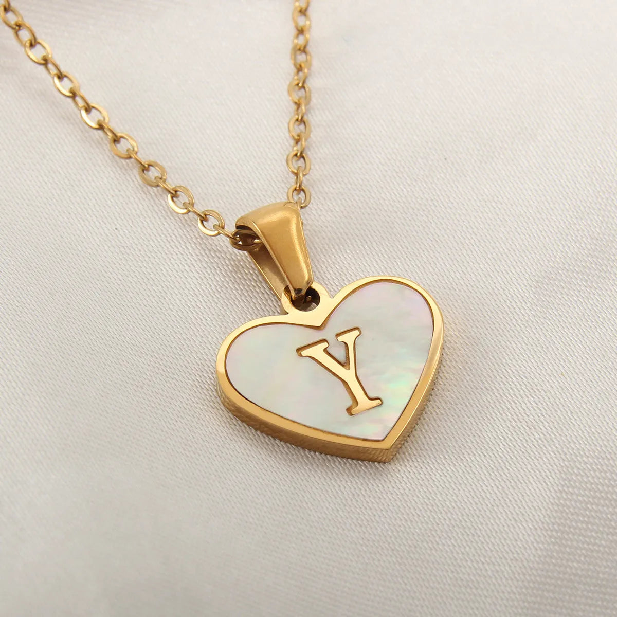 Gold heart necklace with white shell pendant and initial charm on 45cm adjustable chain