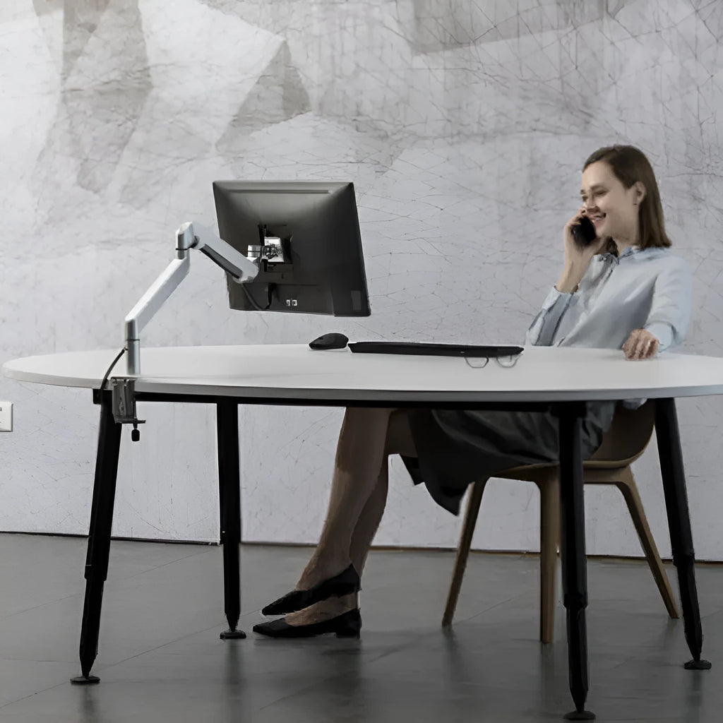 Silver aluminium laptop stand with hover design and air pressure arm bracket elevating a notebook