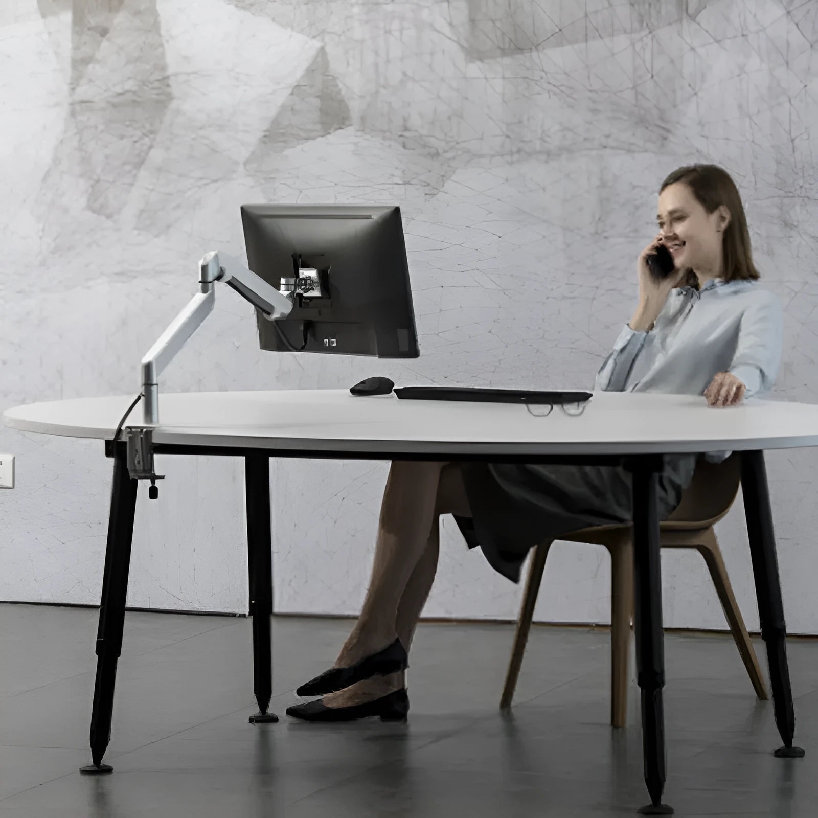 Silver aluminium laptop stand with hover design and air pressure arm bracket elevating a notebook