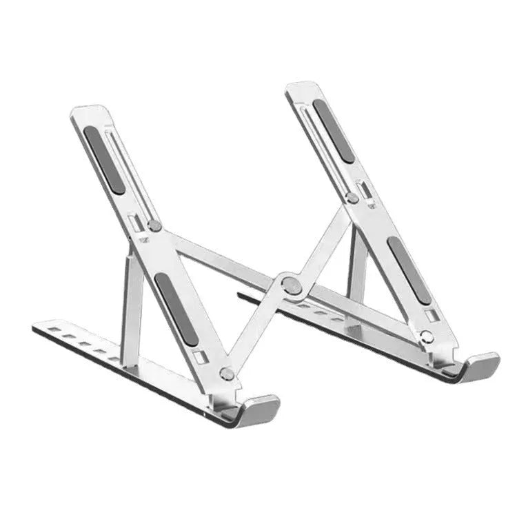 Silver aluminium alloy folding laptop stand with black silicone pads on a wooden desk.