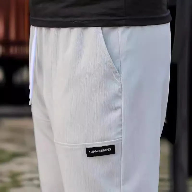 Men's polyester trousers for spring and autumn in light grey colour on a size chart