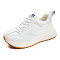 Beige women's low-top leather casual sports shoes with lace-up fastening and round toe.