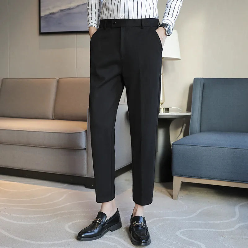Straight-leg brown corduroy trousers with an elasticated waistband laid flat.
