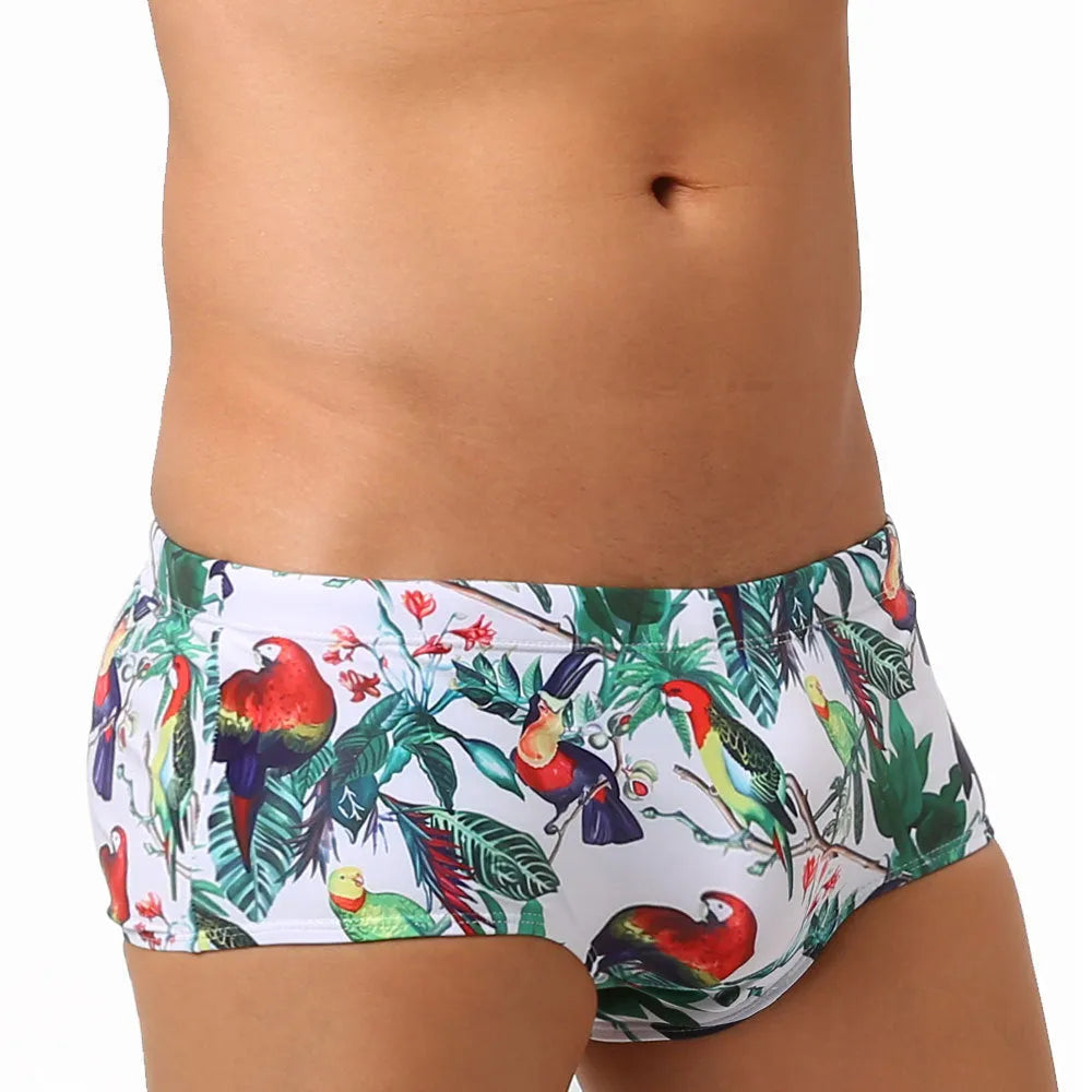 Men's floral bird print swimming trunks in nylon fabric, shown in small boxer style.