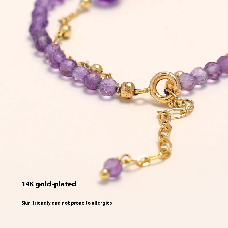 Chinese style women's bracelet with electroplated metal and amethyst crystal stones cut in diamond shapes.