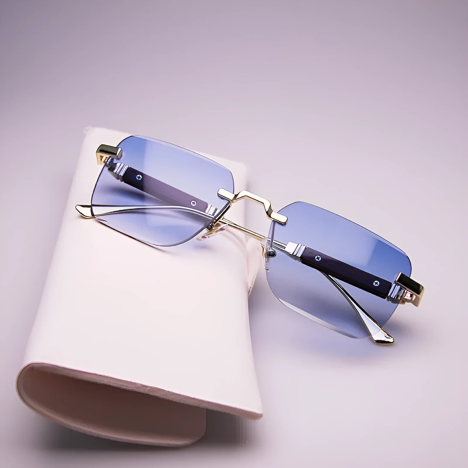Frameless edge-cut sunglasses with gold frame, wood grain legs, and gradient grey lenses on a neutral background