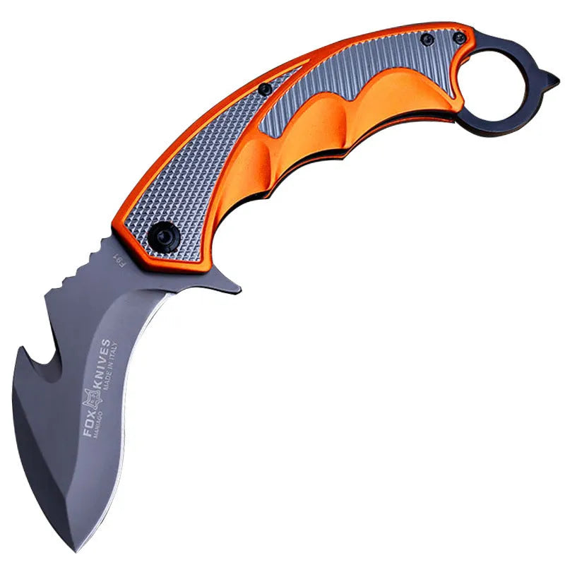 Orange folding knife with steel handle and 8.2cm blade open on outdoor surface showing total length and grip texture