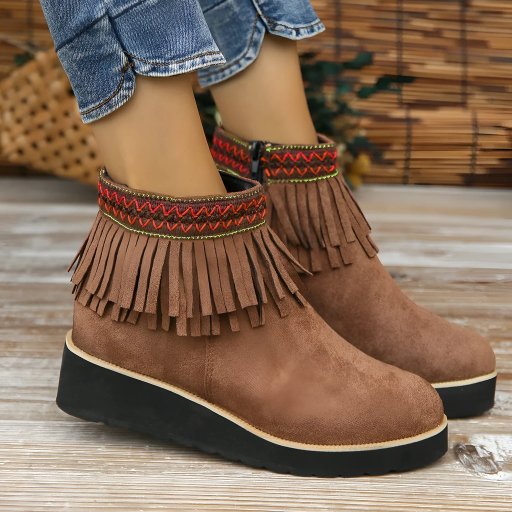 Women's black suede wedge ankle boots with side zipper and decorative tassel on a thick rubber sole.
