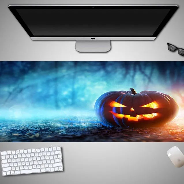 Oversized Halloween-themed gaming mouse pad with non-slip base on a desk.