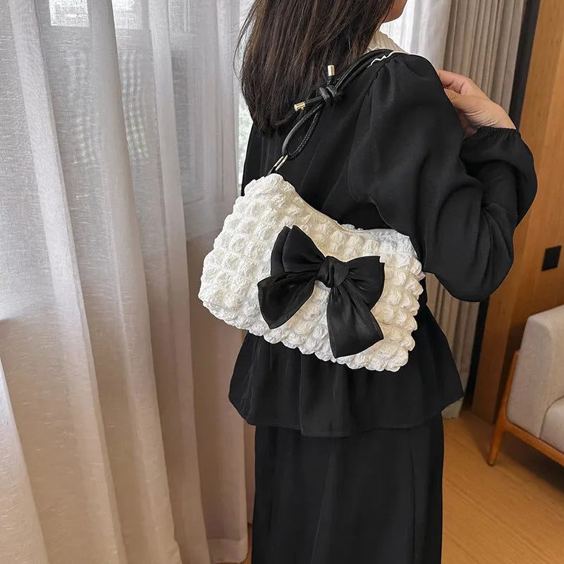 Women's casual canvas handbag with single shoulder strap in black, white, or pink colours showing sandwich pocket design