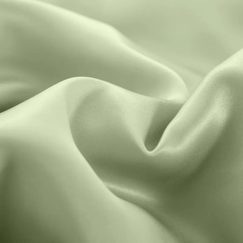 Double-sided silk duvet cover in a solid colour, shown in bright brown on a bed.