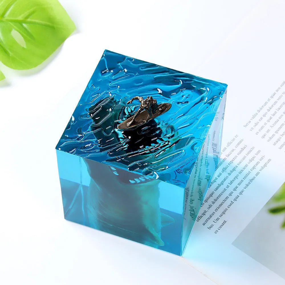 Clear epoxy resin ornament with a detailed shark surfing scene inside, shown next to its integrated lamp holder.