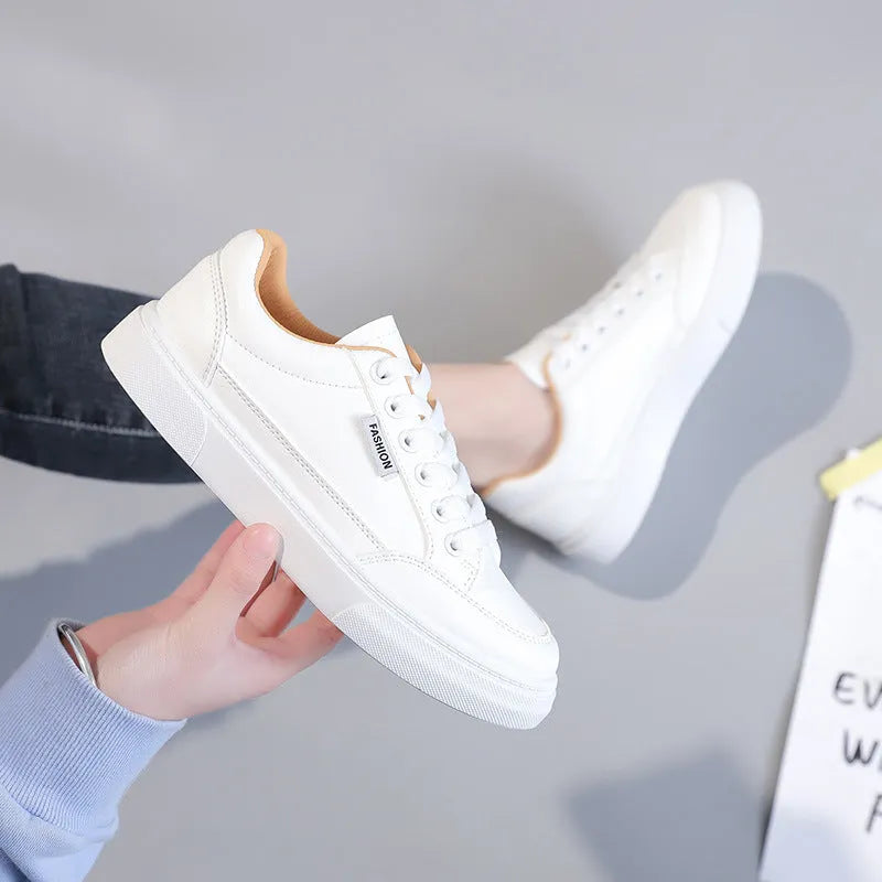 Korean style white and brown low-top women's sneakers on a solid background.