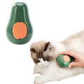Green and white rechargeable cat steam grooming brush with silicone teeth on a wooden table.