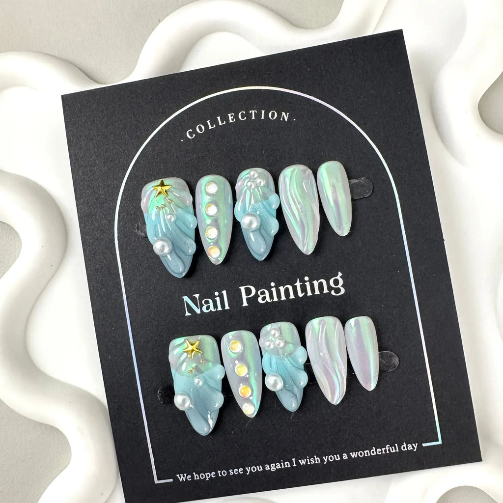 Blue plastic nail stickers and wearable nail armour pieces set on a white background.