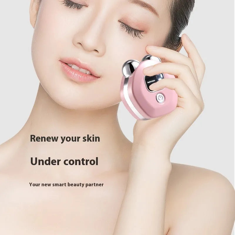 Portable white facial massage instrument with dual rollers and a USB charging cable.