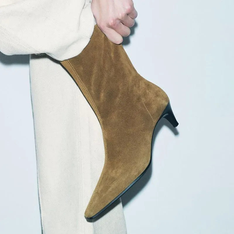 Brown women's square toe mid-calf boots with a side zipper and a low kitten heel on a wooden floor.