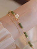 Natural green olivine bracelet with double layer design and Bells of Ireland charms