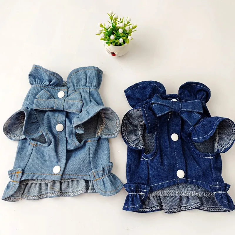Blue denim dog dress with a ruffled vest design and a metal leash hook on the chest.