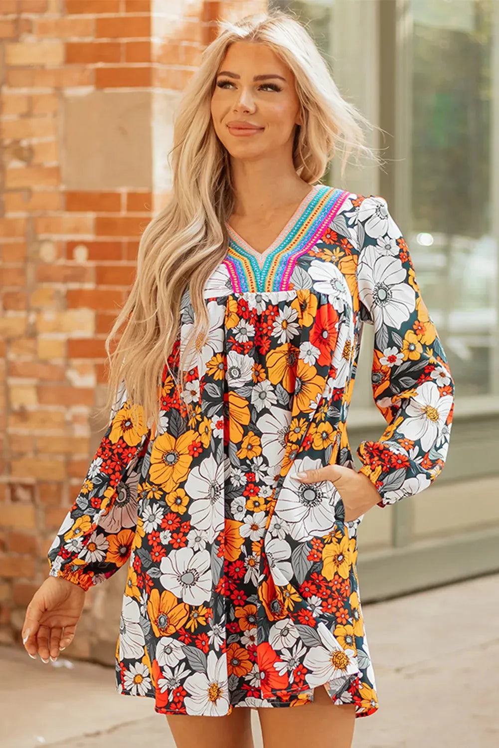 Orange floral print women's mini dress with striped lace detailing, v-neck, and long sleeves
