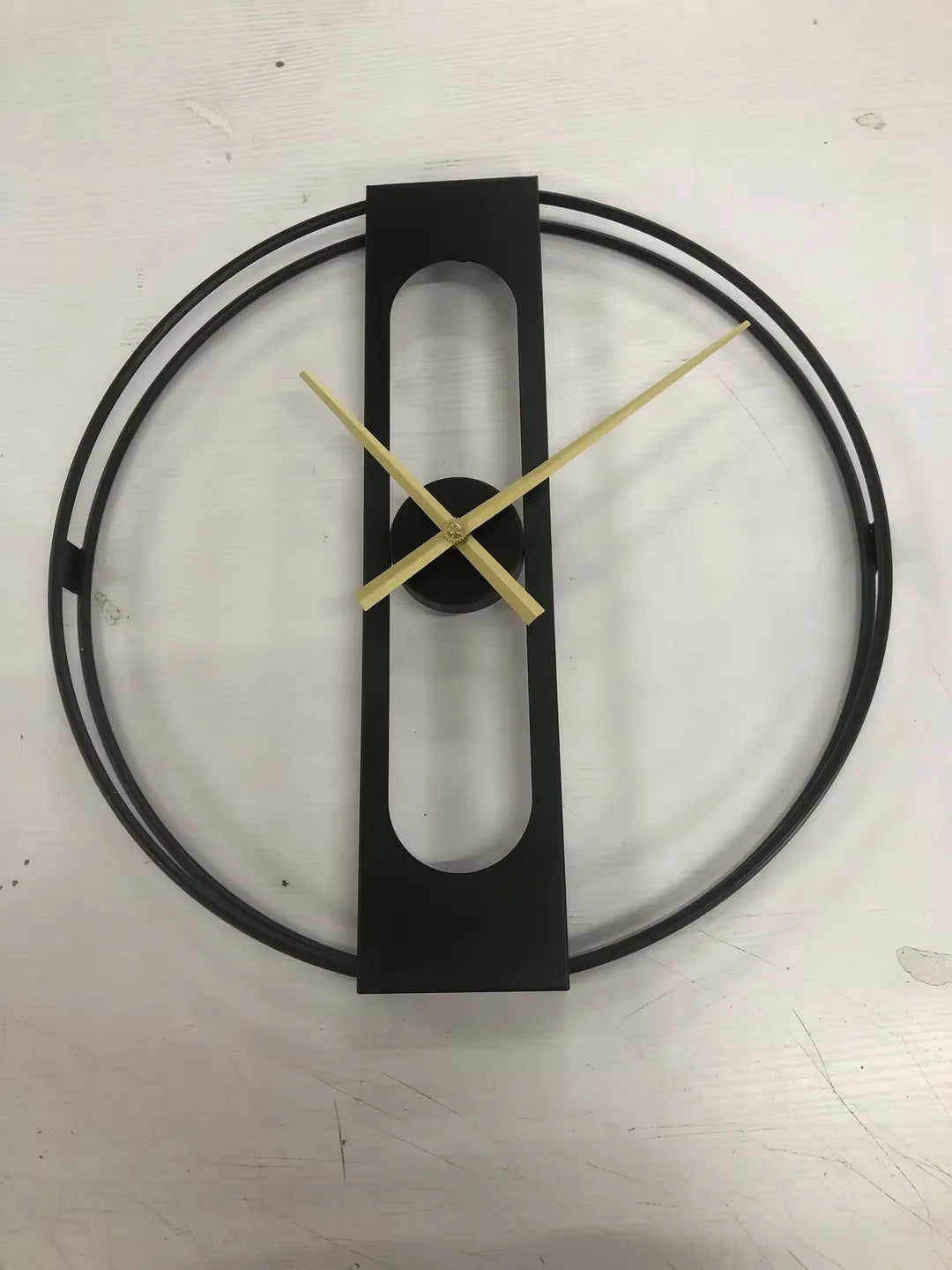 Round metal wall clock measuring 50cm in diameter, available in black and gold colour options