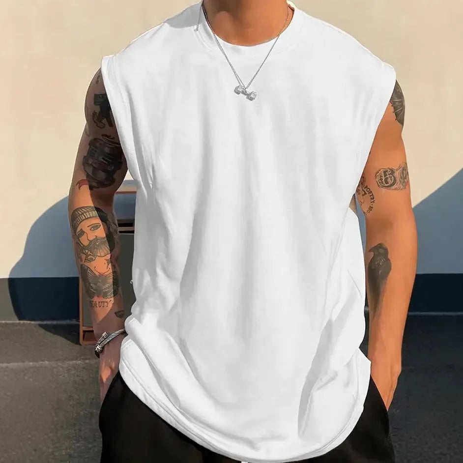 Man wearing a loose solid-colour cotton sleeveless pullover tank top.