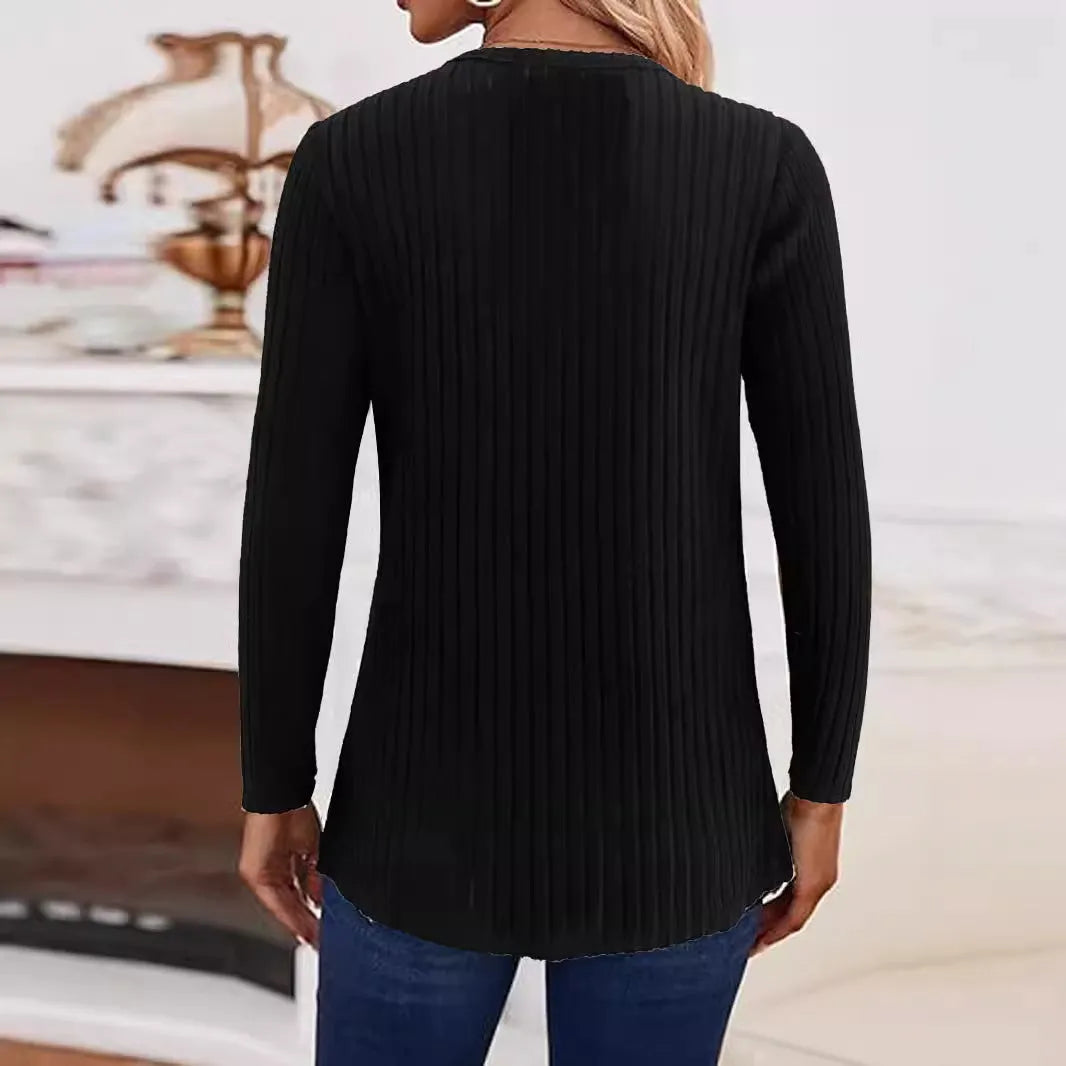 Women's black knitted pullover sweater with a button detail on the front.