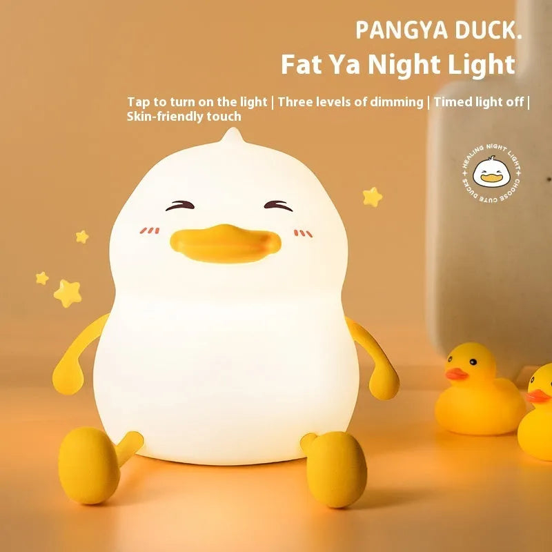 Chubby silicone desktop night light with phone holder showing soft LED illumination