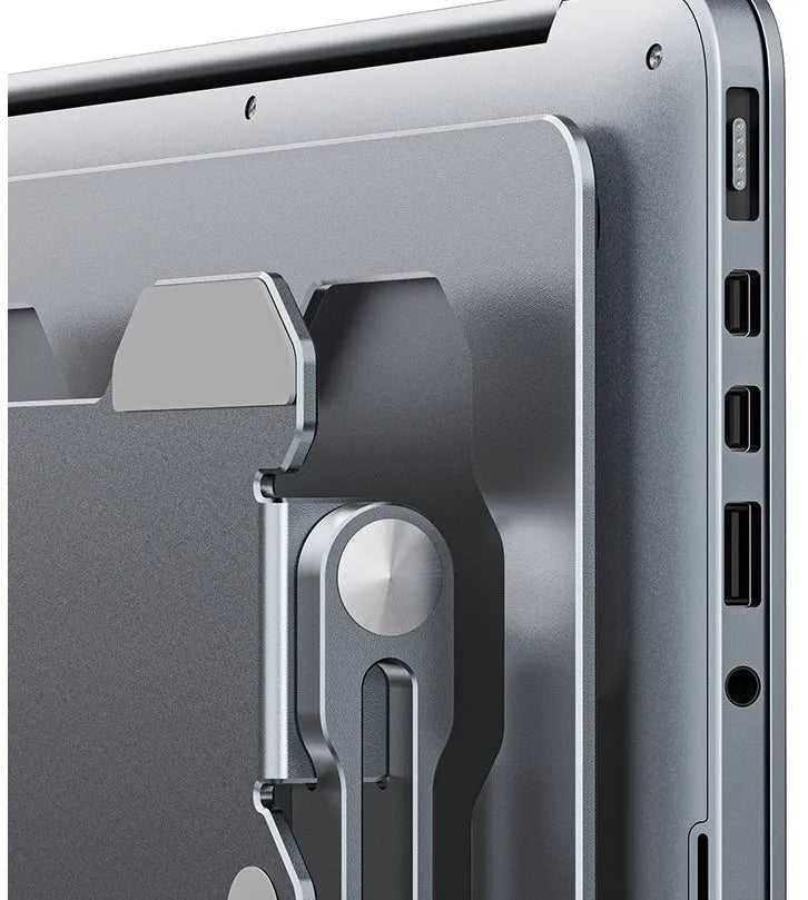 Grey adjustable aluminium laptop stand with hollow design, shown holding a silver laptop.