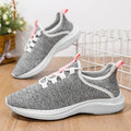 Women's low-top casual sneakers in black, pink or grey with breathable mesh upper and front lace-up fastening.