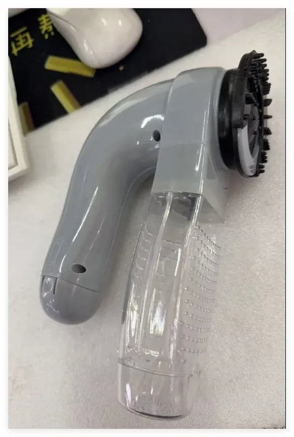 Grey portable electric pet hair vacuum cleaner with soft rubber head for dogs and cats.