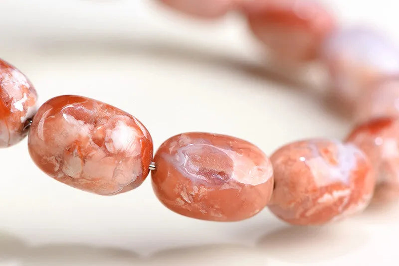 Natural cherry agate bracelet with barrel shaped beads and carved Ruyi symbols