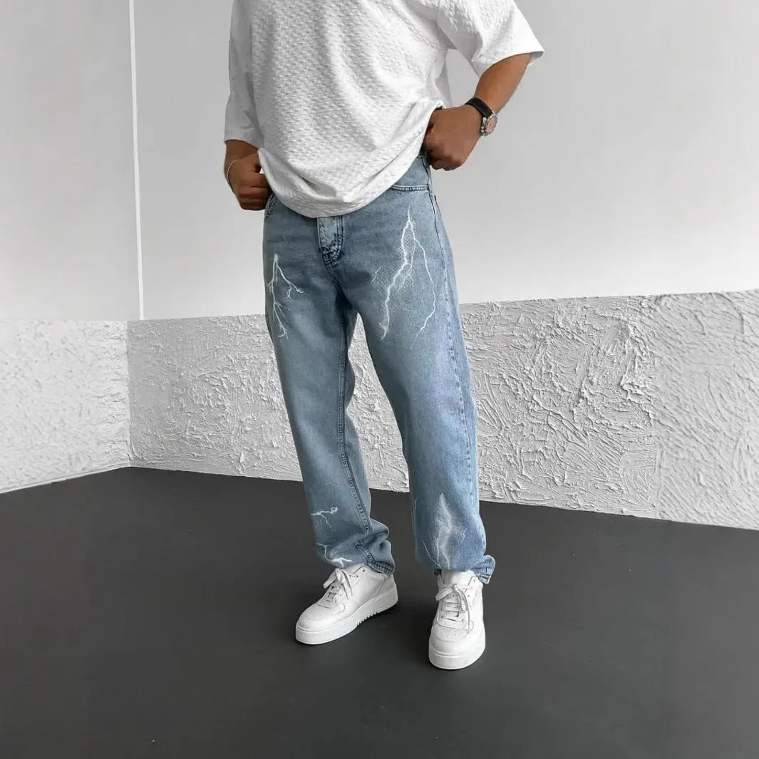 Men's blue straight-leg denim trousers with mid waist and zipper fly on neutral background