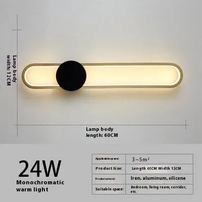 Round modern minimalist wall lamp with iron shade in black or gold finish.