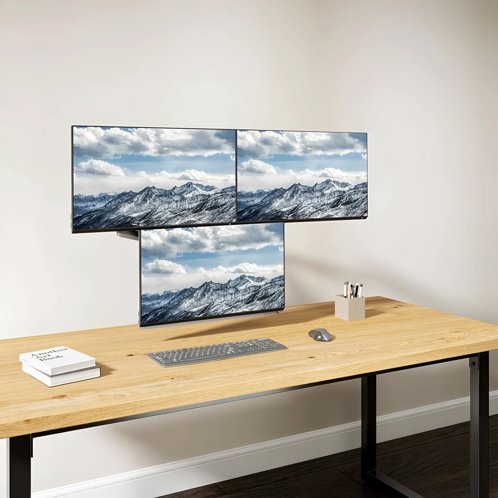 Black aluminium gas spring monitor arm holding 27-inch screen with three-arm construction