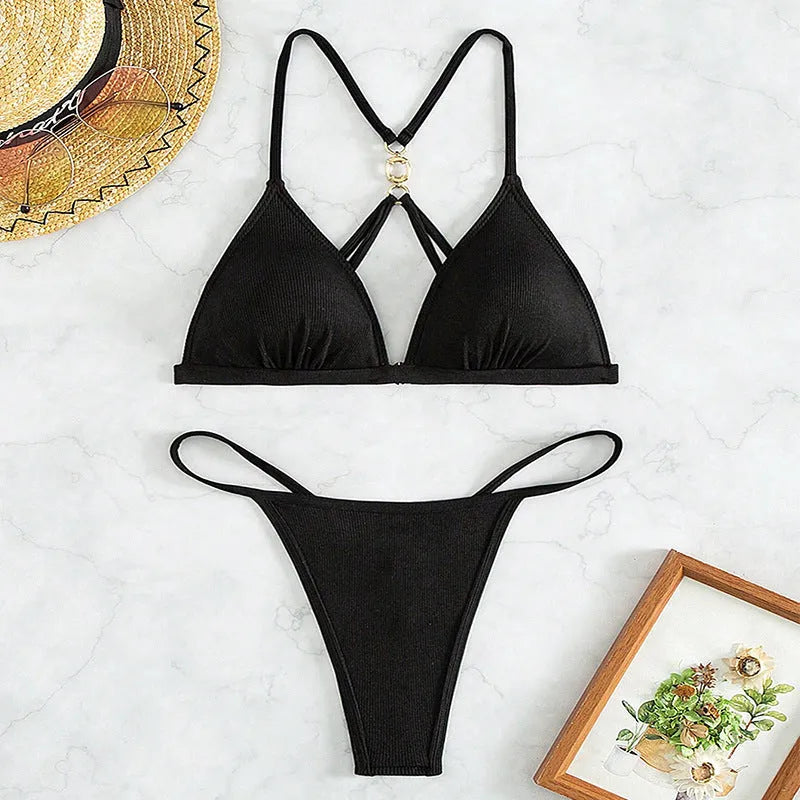 Black women's bikini set with hollow back and triangle top on a neutral background.